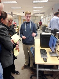 Student presenting his research on a computer